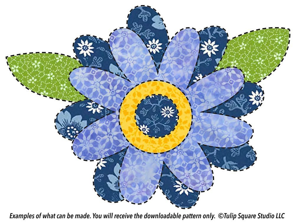 Layers of flowered fabric in shades of blue create a whimsical flower in appliqué.