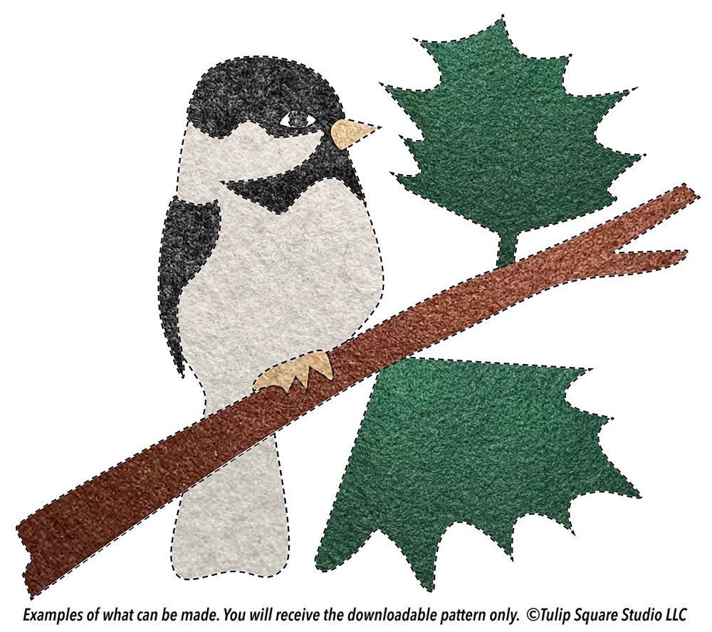 Black and white bird, branch, and leaves, made of felt appliqué.